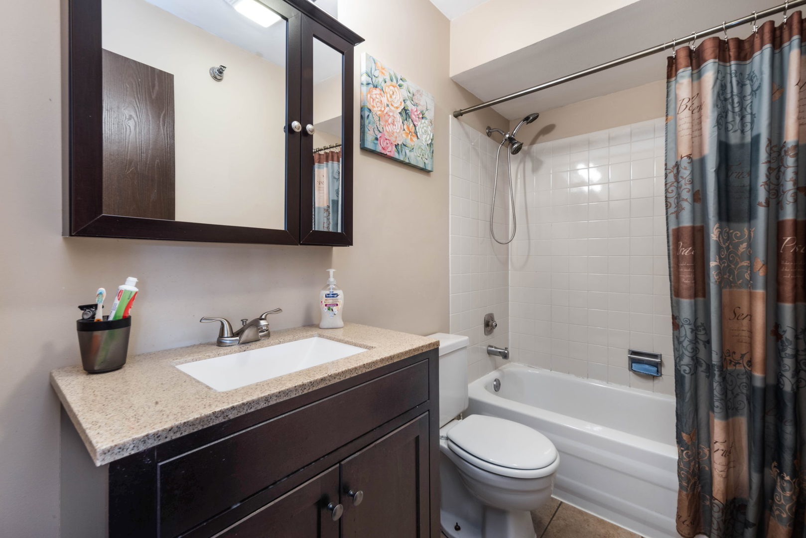 4180 Cove Lane, Unit C Glenview, IL 60025 - Photo 13 of 19 a bathroom with a granite countertop sink toilet and shower