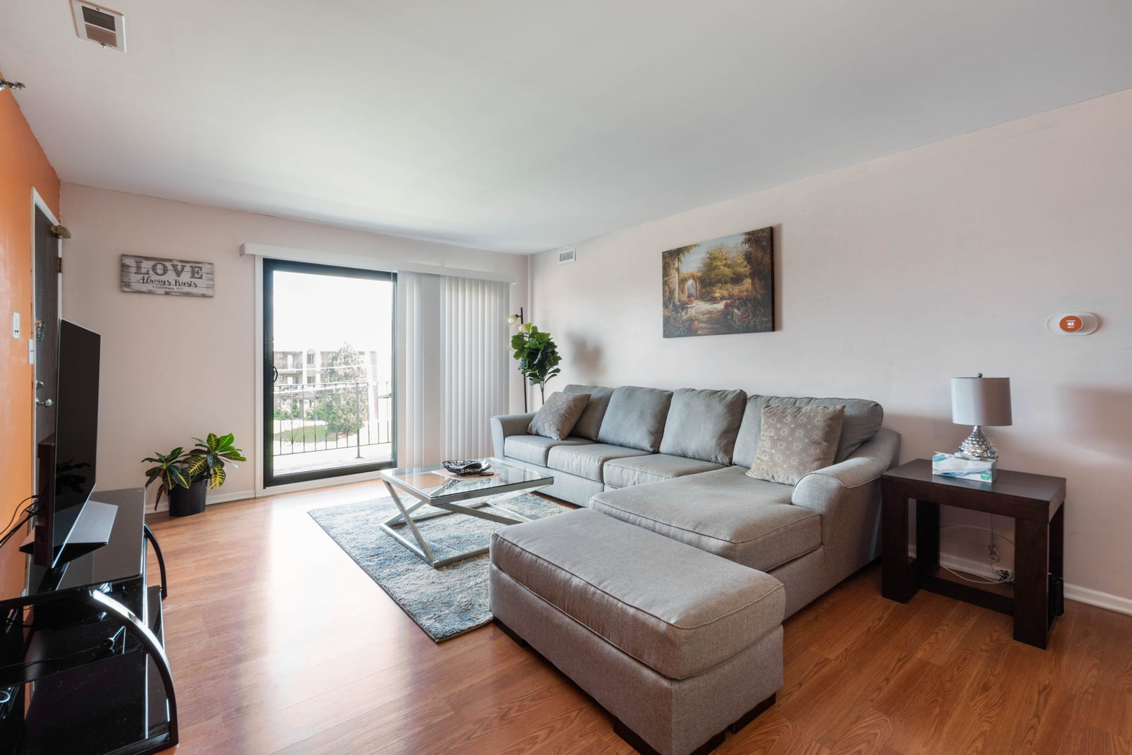 4180 Cove Lane, Unit C Glenview, IL 60025 - Photo 6 of 19 a living room with furniture wooden floor and a flat screen tv