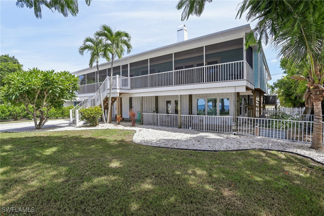 8335 Main Street Bokeelia, FL 33922 - Photo 1 of 47 a front view of a house with swimming pool having outdoor seating