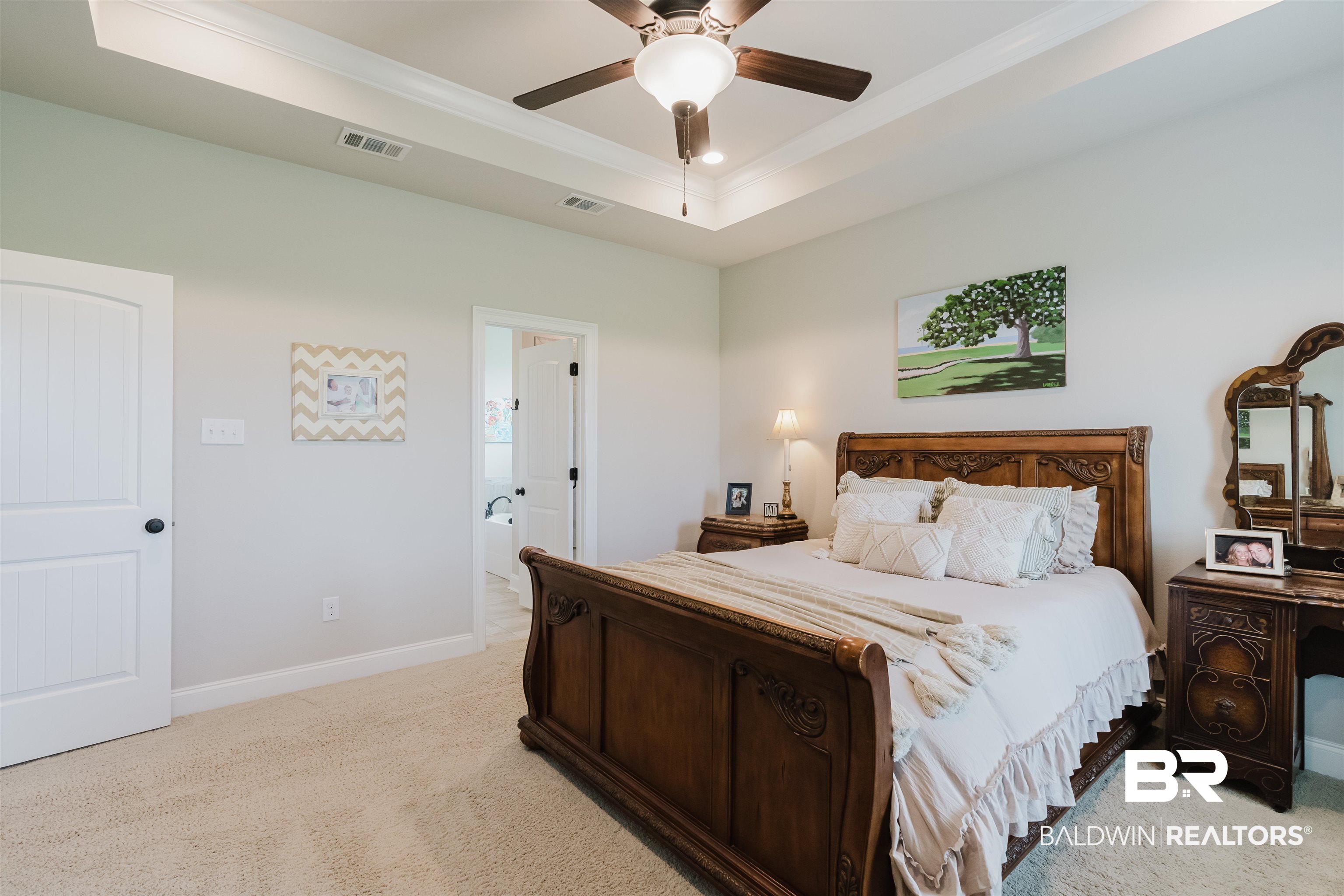 12128 Red Barn Road Fairhope, AL 36532 - Photo 17 of 47 Bedroom featuring ornamental molding, light colored carpet, a raised ceiling, baseboards, and a ceiling fan