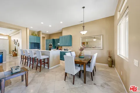 a dining room with furniture a chandelier and window