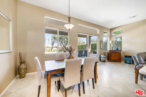a dining room with furniture a chandelier and a rug