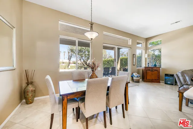 a dining room with furniture a chandelier and a rug