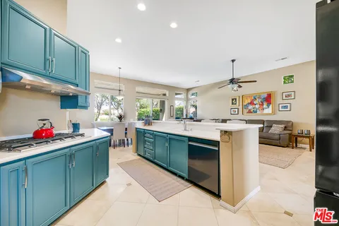 a kitchen with stainless steel appliances kitchen island granite countertop a sink and cabinets