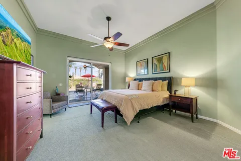 a spacious bedroom with a bed dresser and furniture