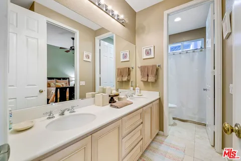 a bathroom with a double vanity sink mirror and double