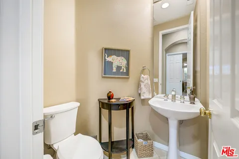 a bathroom with a toilet a sink and a mirror