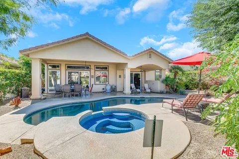 a view of a house with swimming pool and sitting area