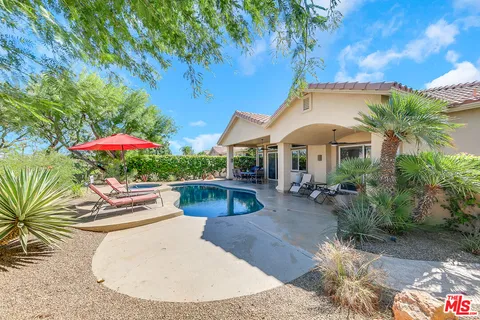 an outdoor sitting area with furniture