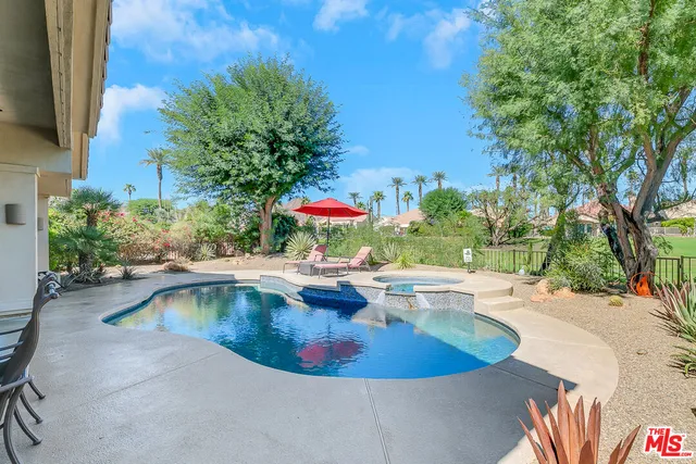 a view of a swimming pool with a yard