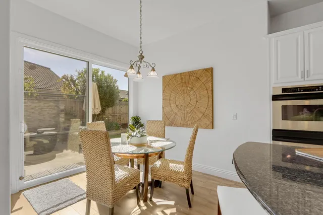 a living room with patio furniture and a potted plant