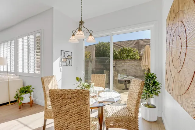 a living room with furniture kitchen and a chandelier