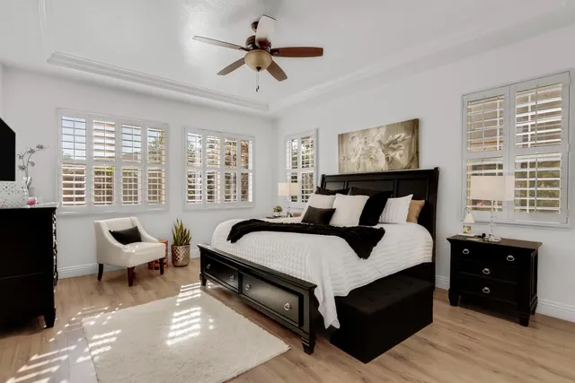 a bed room with a bed and painting on the wall