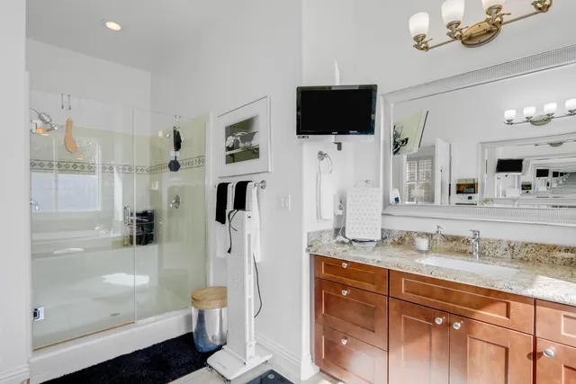 a spacious bathroom with a tub sink and mirror