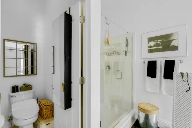 a view of a livingroom with workspace and a window