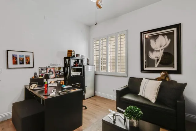 a view of a workspace with furniture and a window