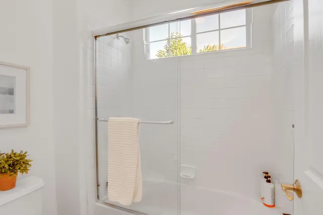 a view of a livingroom with workspace and a window