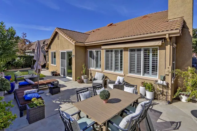 a view of a patio with table and chairs and potted plants