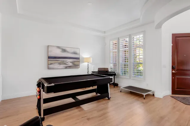a living room with furniture a rug and a large window