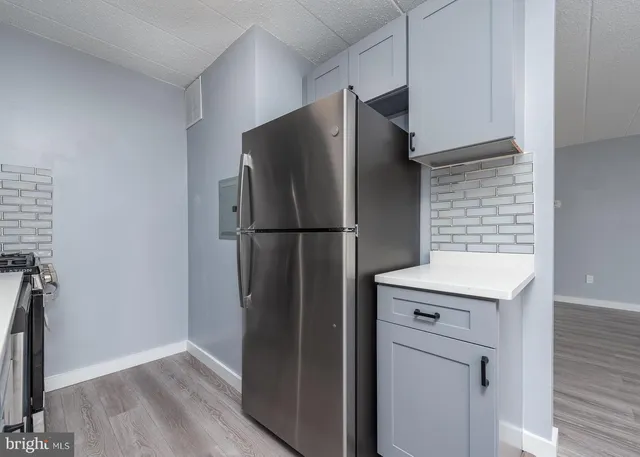 a kitchen with metallic refrigerator freezer and a dishwasher