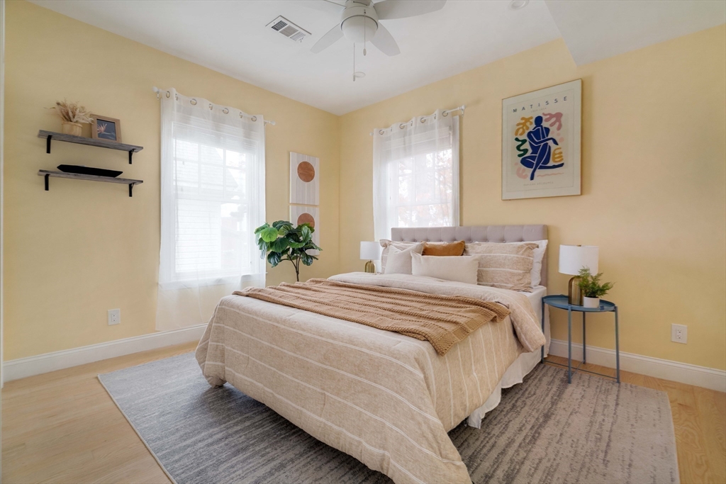 6 Hamilton Road, Unit 6 Somerville, MA 02144 - Photo 12 of 28 a spacious bedroom with a bed and a chandelier
