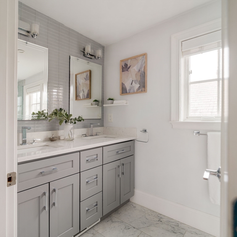 6 Hamilton Road, Unit 6 Somerville, MA 02144 - Photo 23 of 28 a bathroom with double sink and a mirror