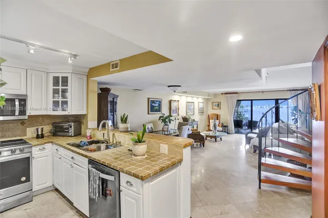 a dining room with furniture and a potted plant