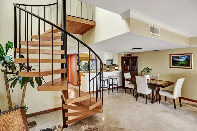 a living room with furniture and large windows