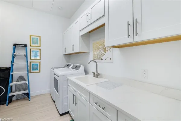 a kitchen with cabinets a sink and appliances