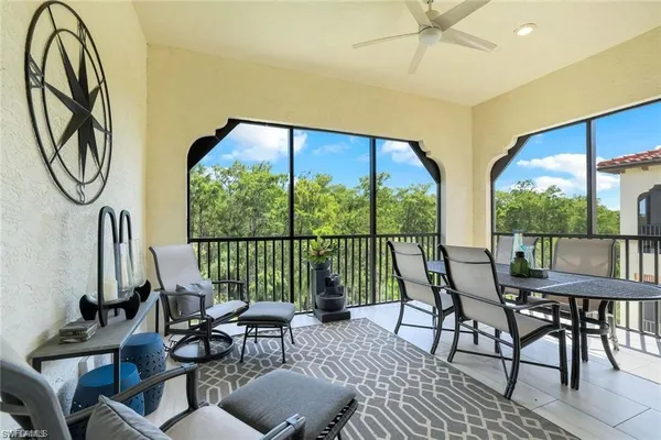 a living room with furniture and a floor to ceiling window