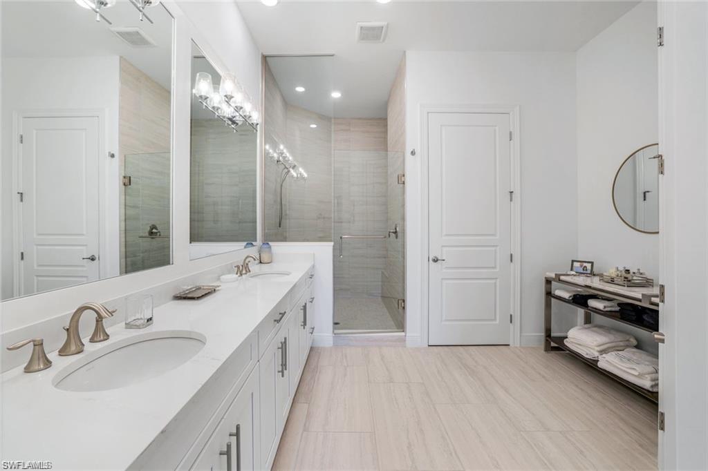 16374 Viansa Way, Unit 5302 Naples, FL 34110 - Photo 10 of 28 Primary bath featuring double vanity, shower