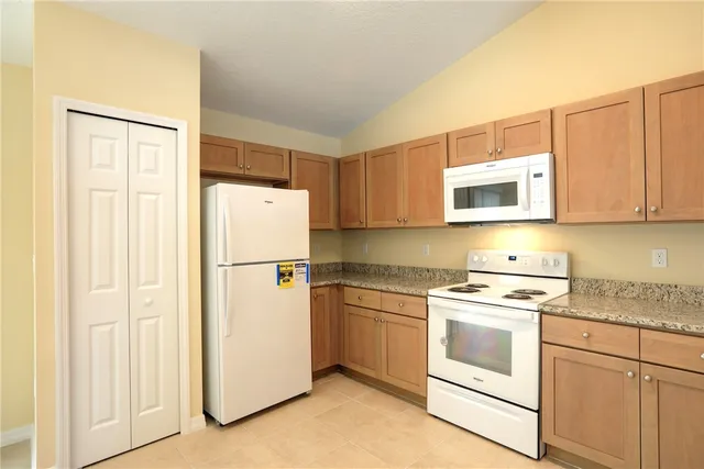a white refrigerator freezer sitting in a kitchen