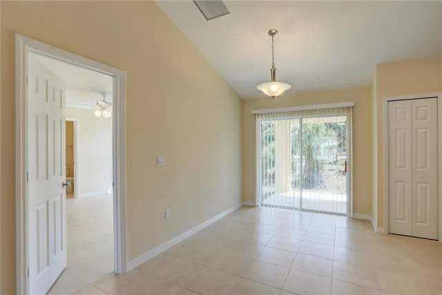 a room that has a window and a ceiling fan