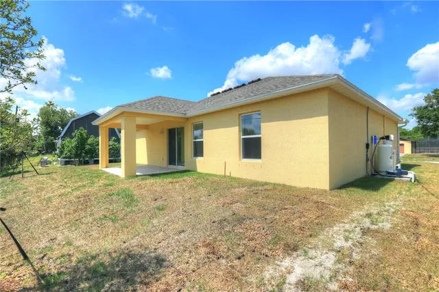 a view of a house with a backyard