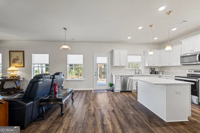 a kitchen with a sink appliances and cabinets