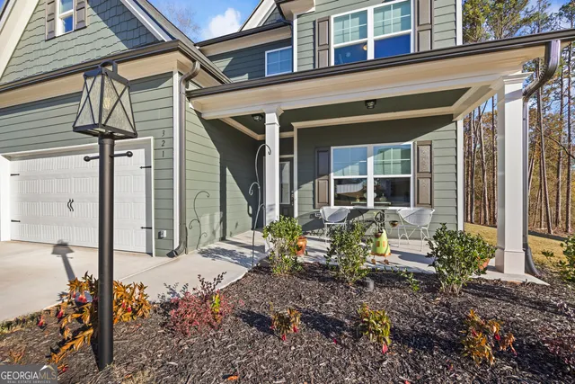 a view of a hallway with wooden floor and livingroom