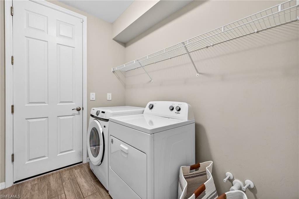 14567 Edgewater Circle Naples, FL 34114 - Photo 26 of 43 a utility room with dryer and washer
