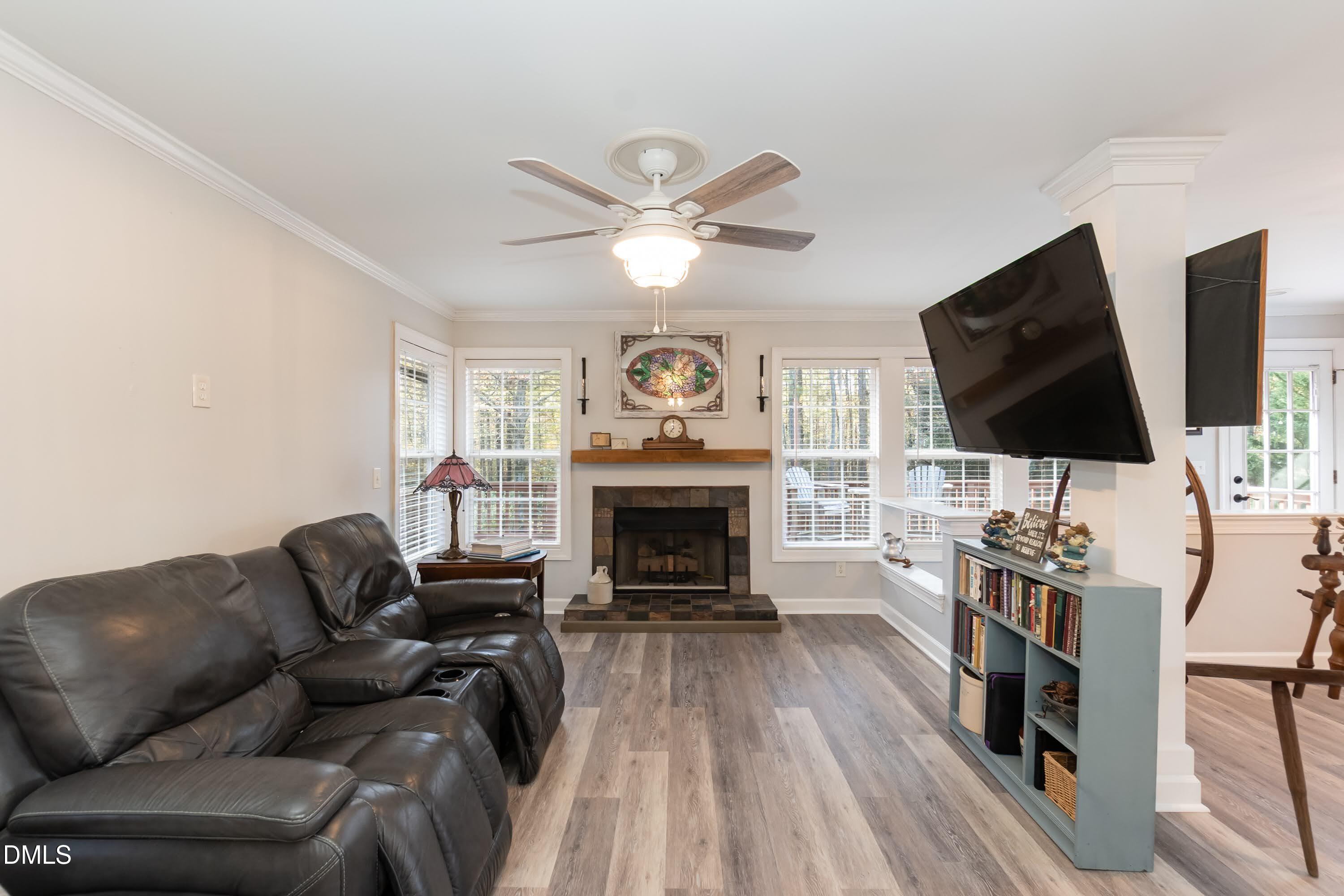 137 Fox Hunters Lane Broadway, NC 27505 - Photo 13 of 46 a living room with furniture a fireplace and a flat screen tv