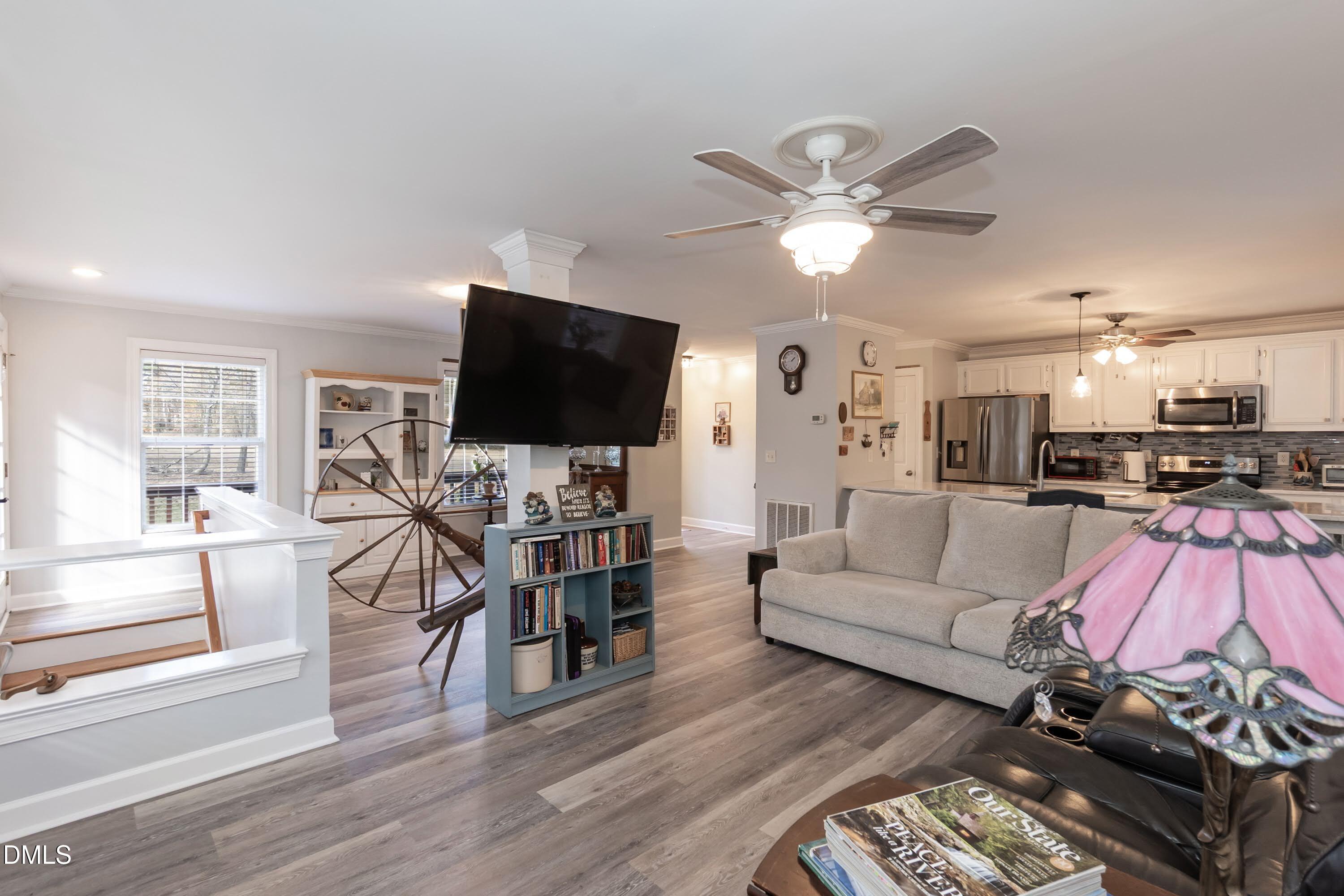 137 Fox Hunters Lane Broadway, NC 27505 - Photo 16 of 46 a living room with furniture and a flat screen tv with wooden floor