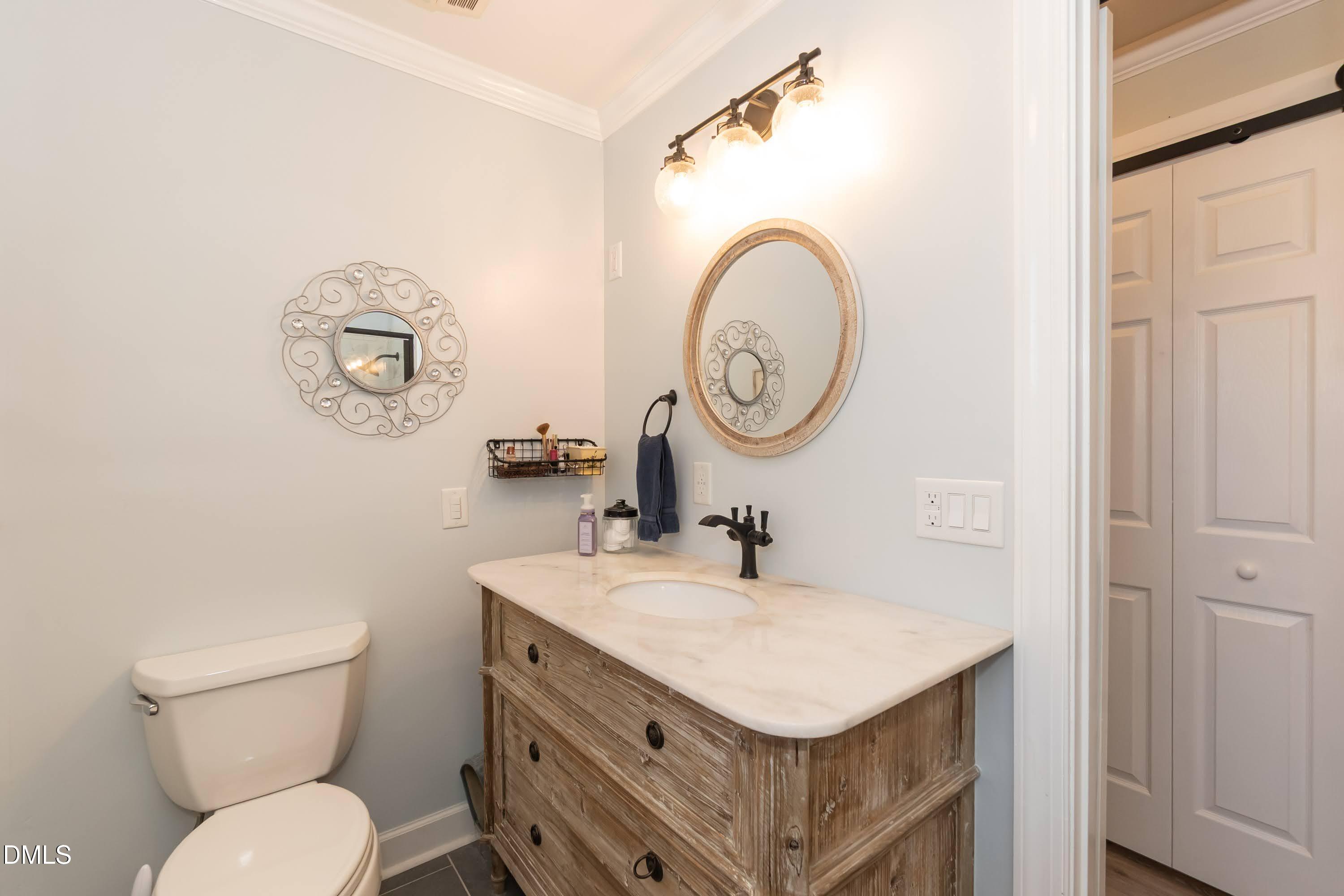 137 Fox Hunters Lane Broadway, NC 27505 - Photo 20 of 46 a bathroom with a toilet a sink and a mirror