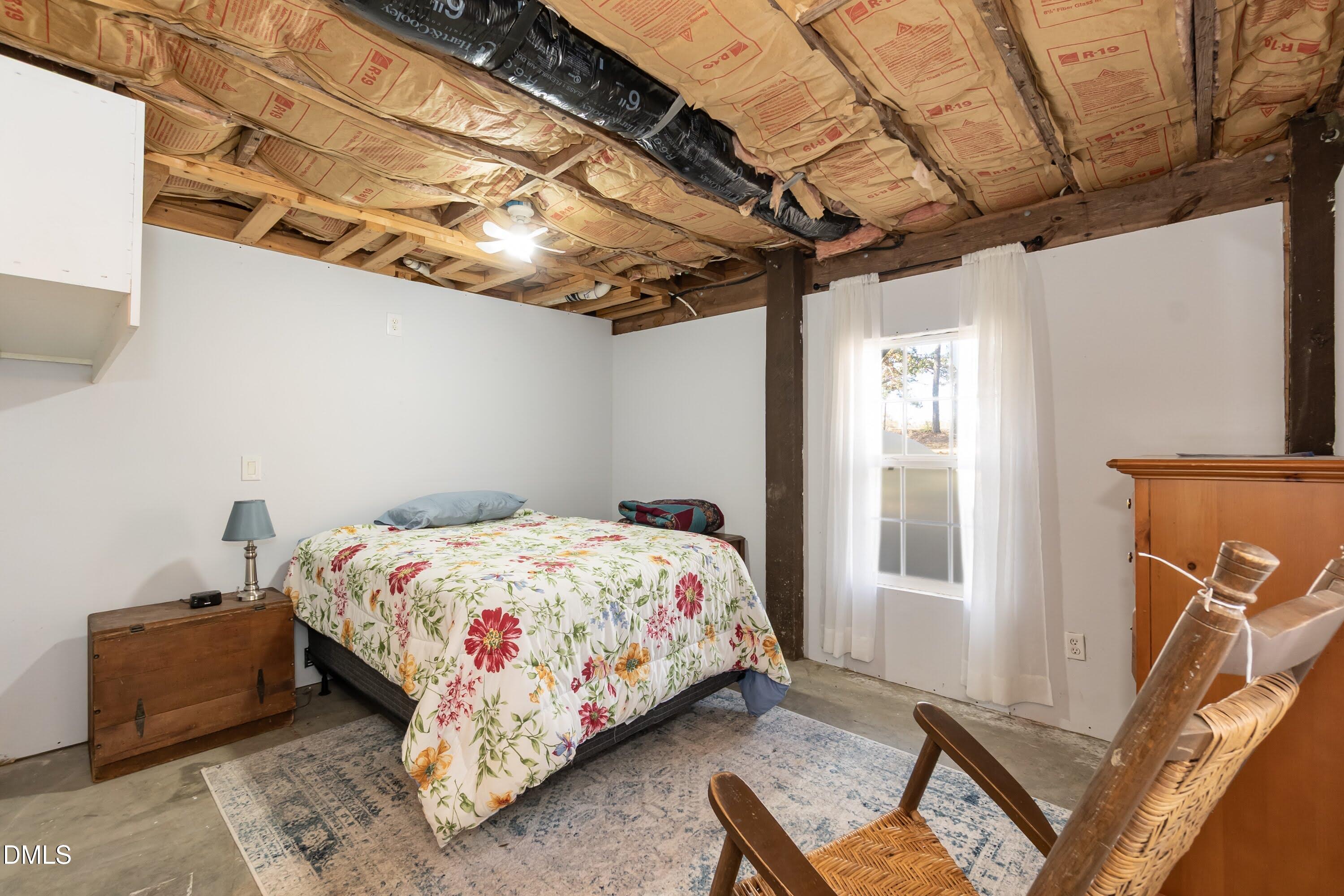 137 Fox Hunters Lane Broadway, NC 27505 - Photo 37 of 46 a bedroom with a bed and a window