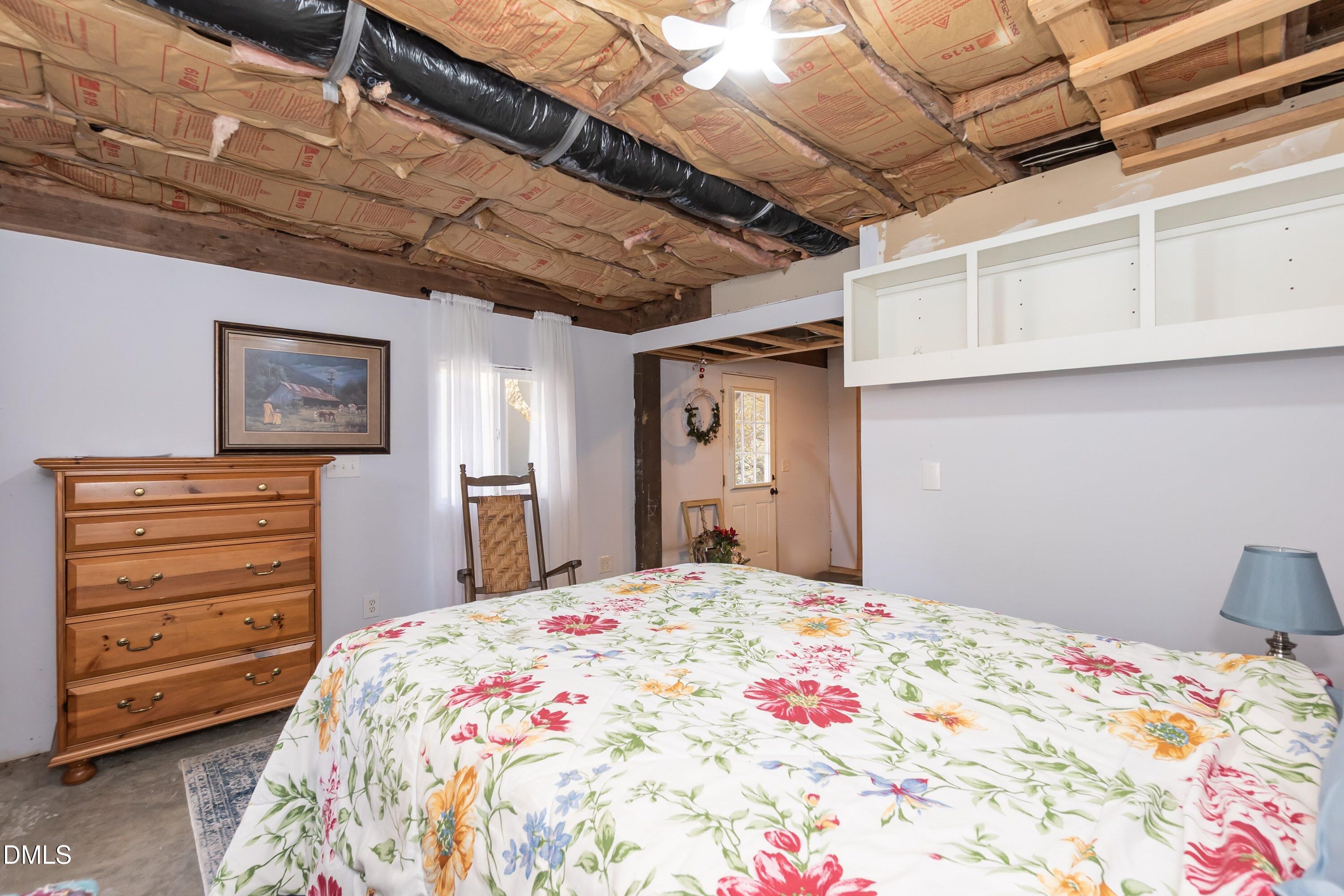 137 Fox Hunters Lane Broadway, NC 27505 - Photo 38 of 46 a bedroom with a bed a dresser and chair