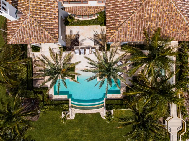 a front view of multiple houses with yard