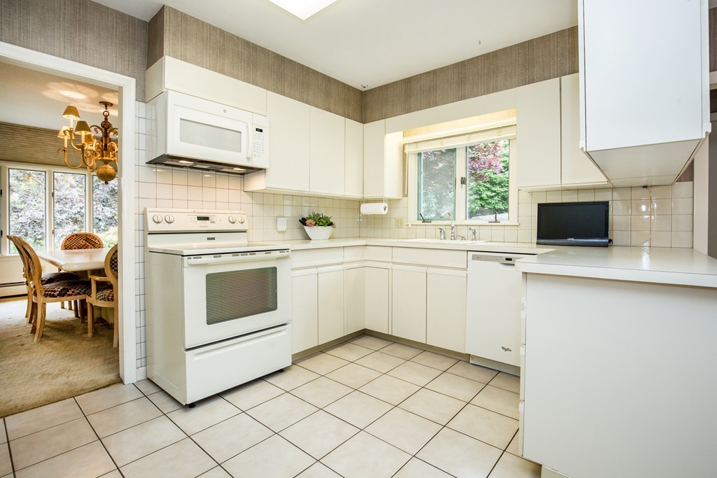 16 Gerald Road Marblehead, MA 01945 - Photo 8 of 28 a white kitchen with a stove top oven sink and cabinets