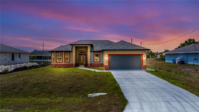 a front view of a house with a yard and garage