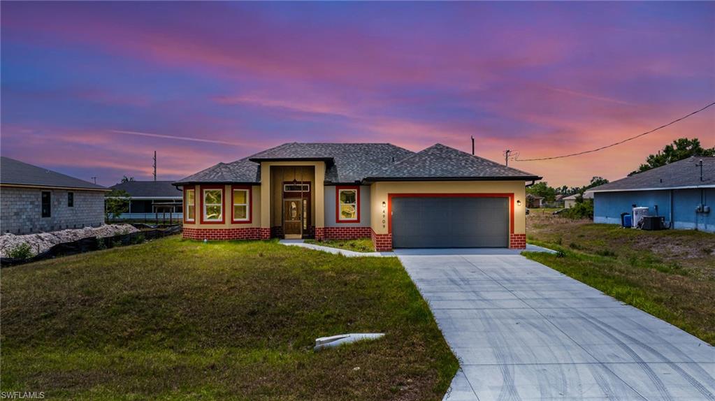 a front view of a house with a yard and garage