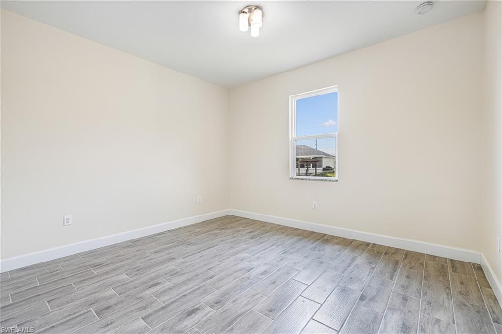 4909 Berryman Street Lehigh Acres, FL 33971 - Photo 14 of 30 Spare room with wood tiled floors