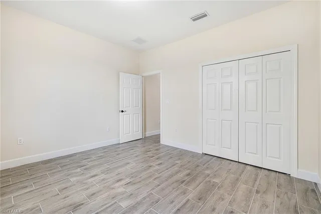 a view of an empty room and wooden floor