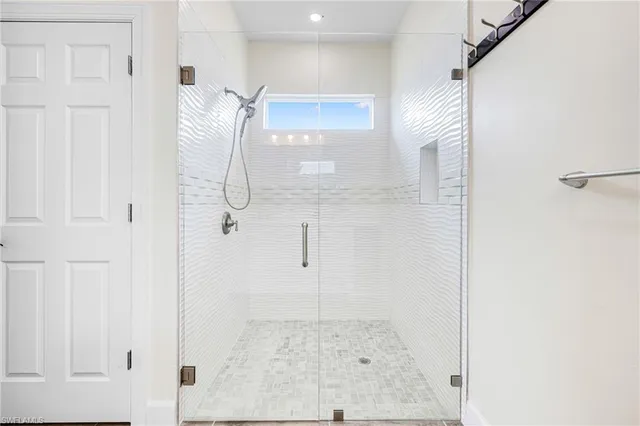 a bathroom with a glass shower door