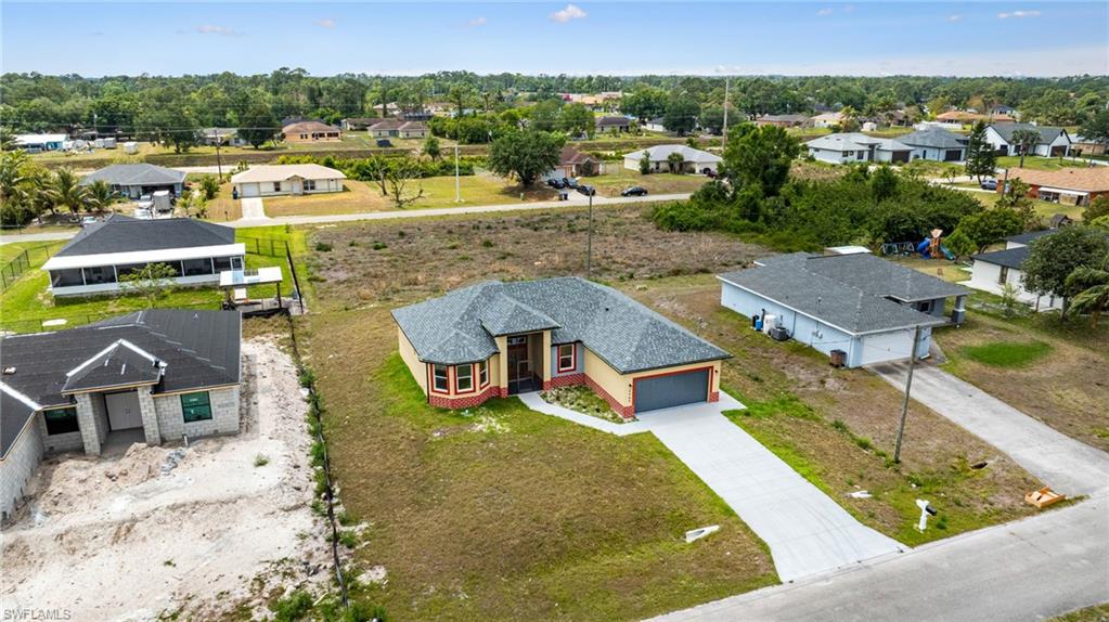 4909 Berryman Street Lehigh Acres, FL 33971 - Photo 26 of 30 Aerial perspective of suburban area